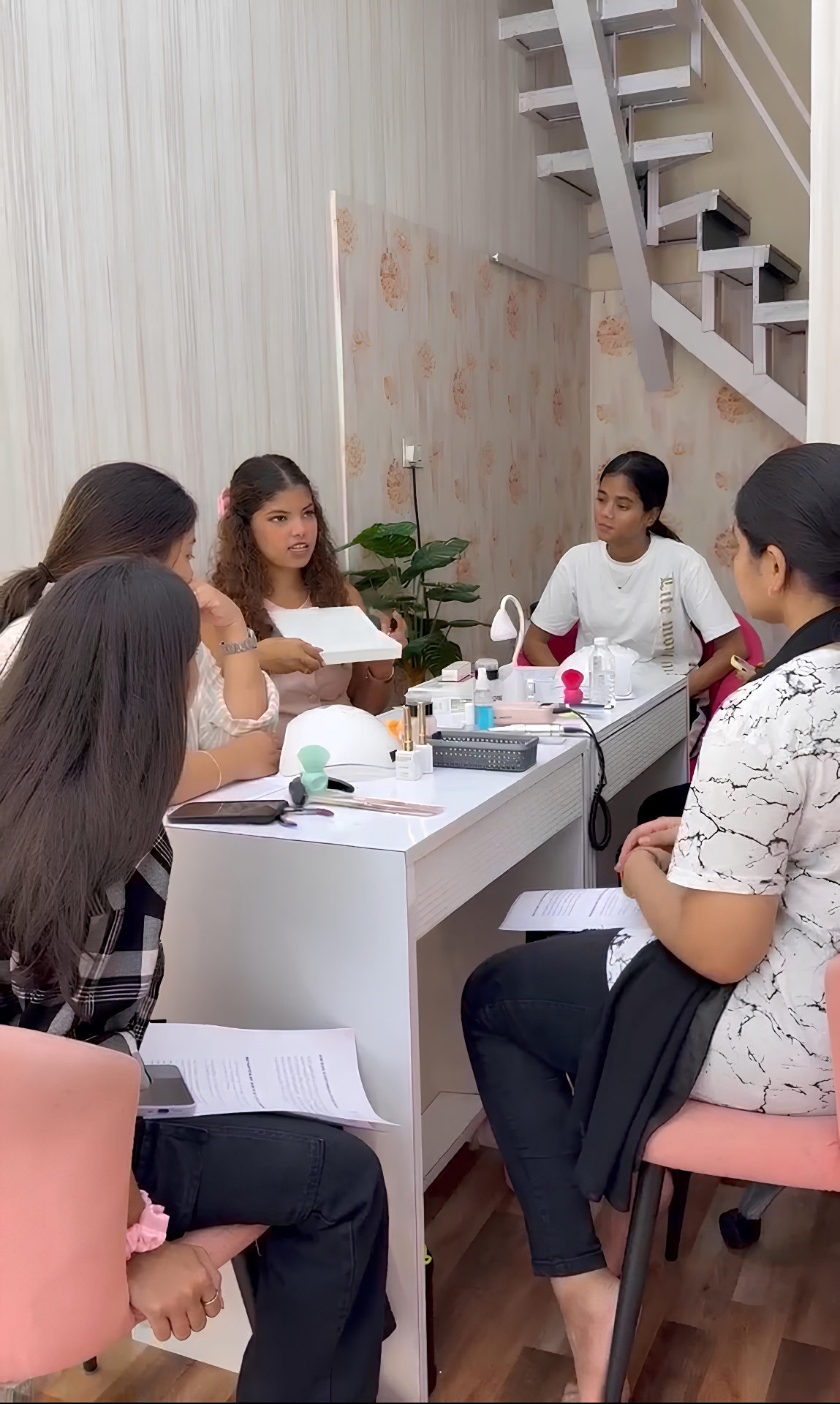 V Nailed It Academy students in a hands-on training session
